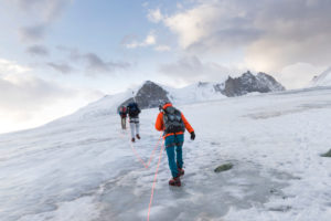 Mountaineer on the way to the Bishorn summit, roped for safety on the glacier Mountaineer on the way to the Bishorn summit, roped for safety on the glacier